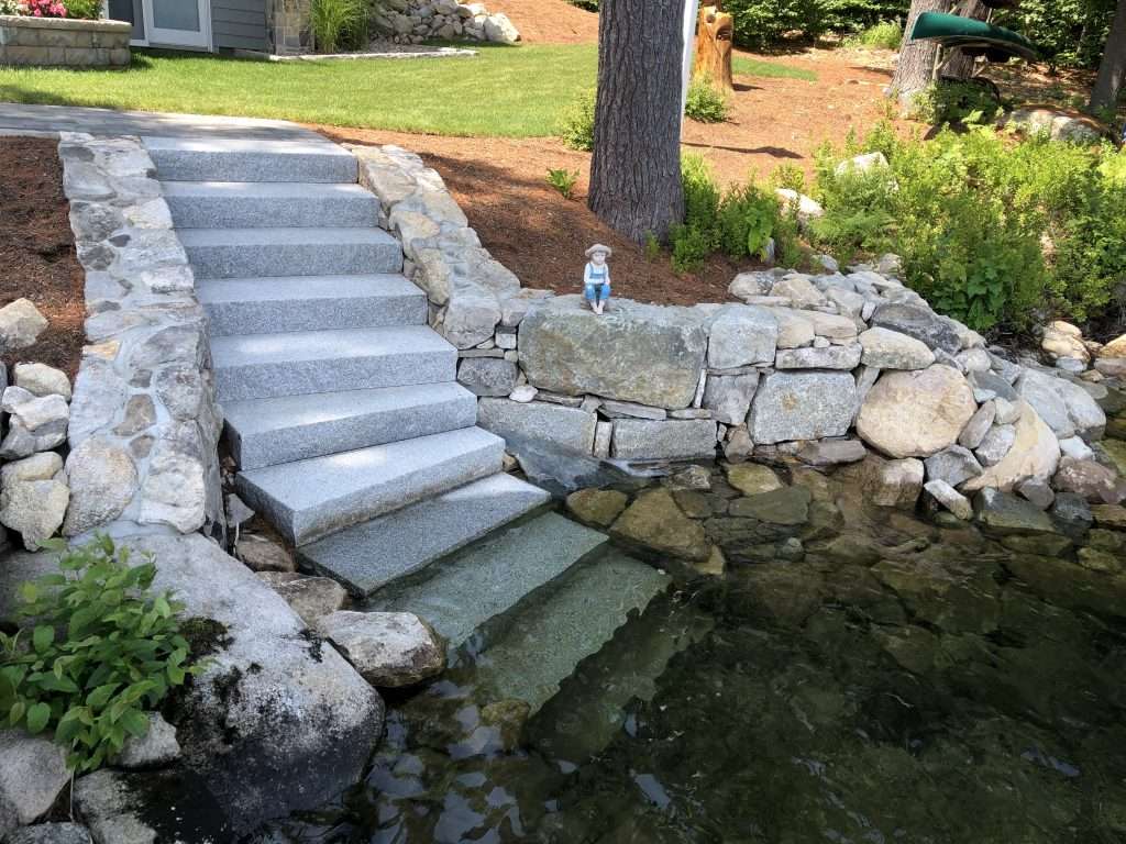 granite steps down to lake with stacked stone walls