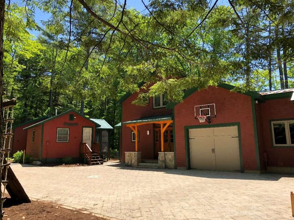 Custom paver driveway and courtyard installation for a woodland New Hampshire home by Landscapes by Tom