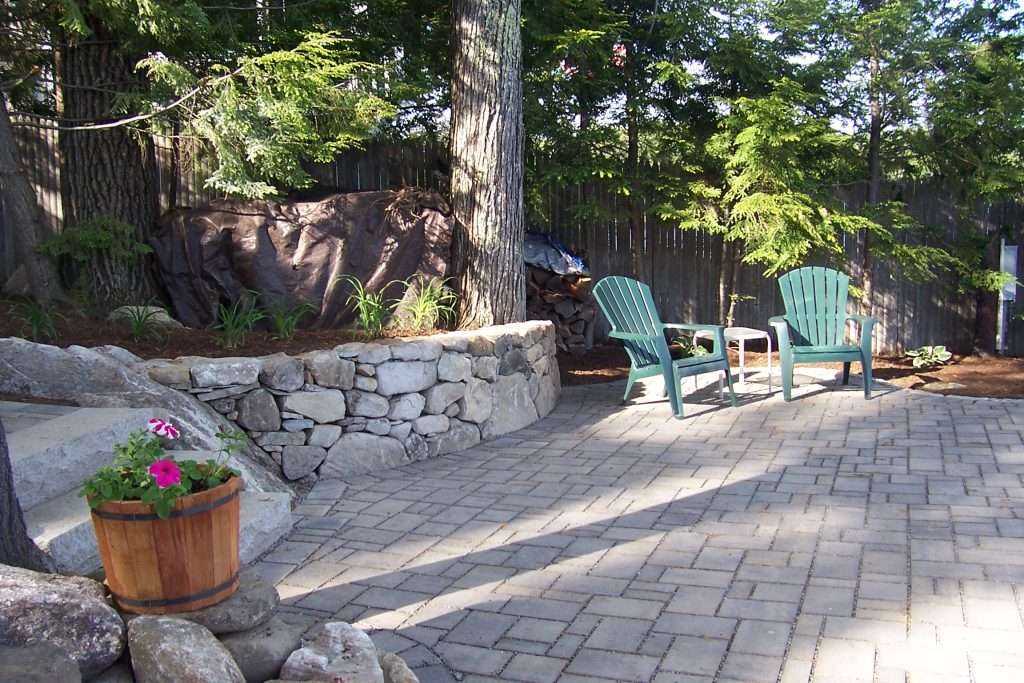 Custom natural stone patio and walkway installation with professional landscape design by Landscapes by Tom in New Hampshire
