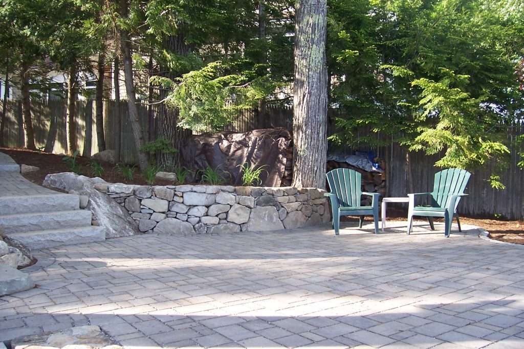 paver patio with stacked stone wall