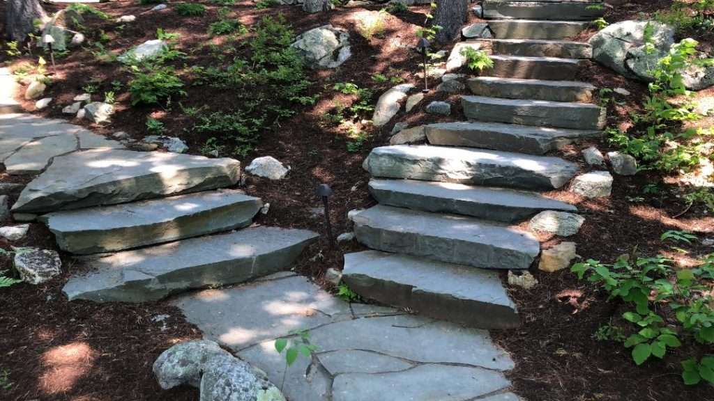 Custom granite stone staircase and woodland pathway by Landscapes by Tom in New Hampshire