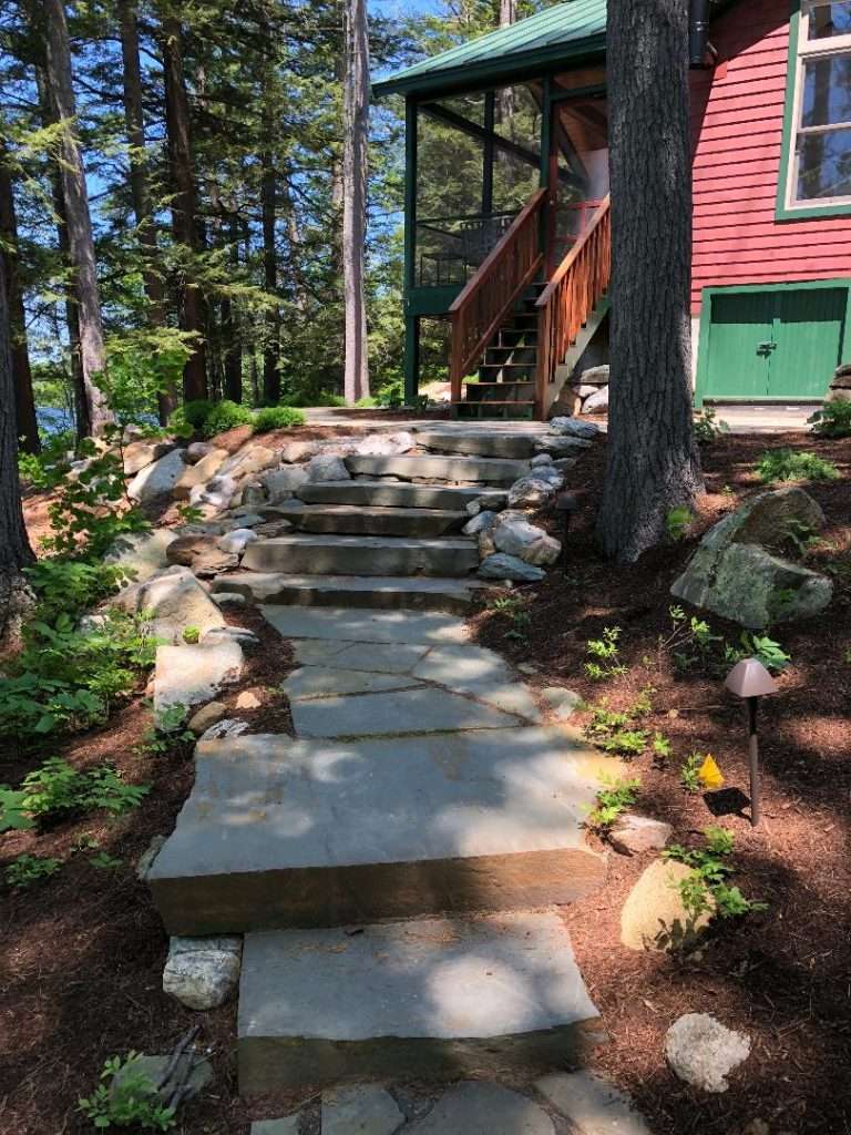 Woodland natural stone steps and pathway installation for a lakeside New Hampshire home by Landscapes by Tom