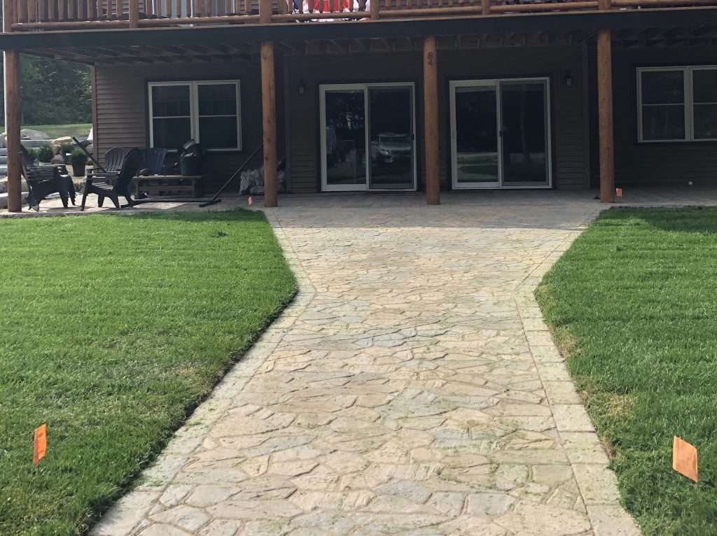 Completed bluestone walkway installation with natural stone landscaping and professional hardscape design by Landscapes by Tom in New Hampshire