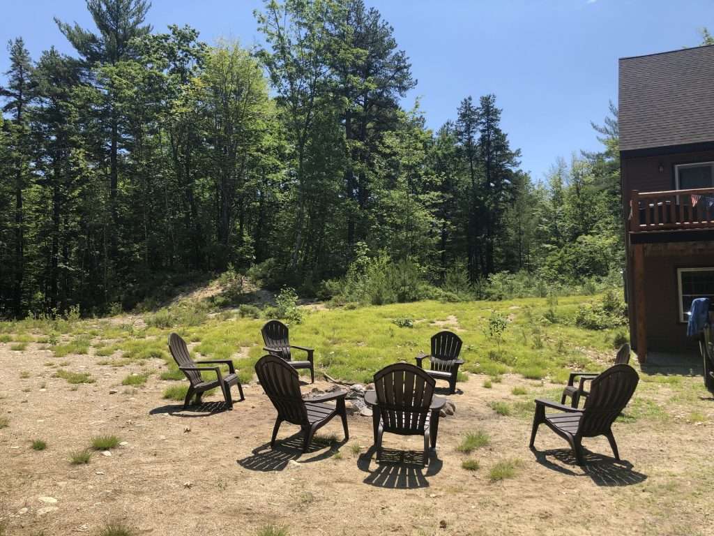 Before photo of a backyard area prior to stone and gravel fire pit installation by Landscapes by Tom in New Hampshire