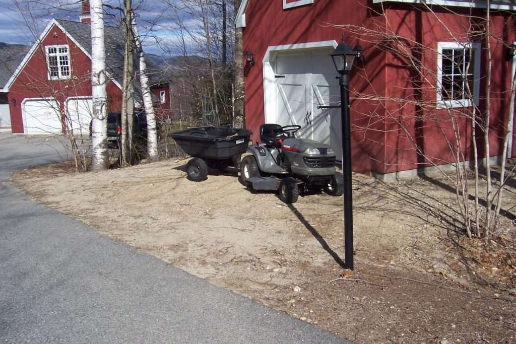 Before photo of a residential driveway prior to custom paver driveway installation by Landscapes by Tom in New Hampshire