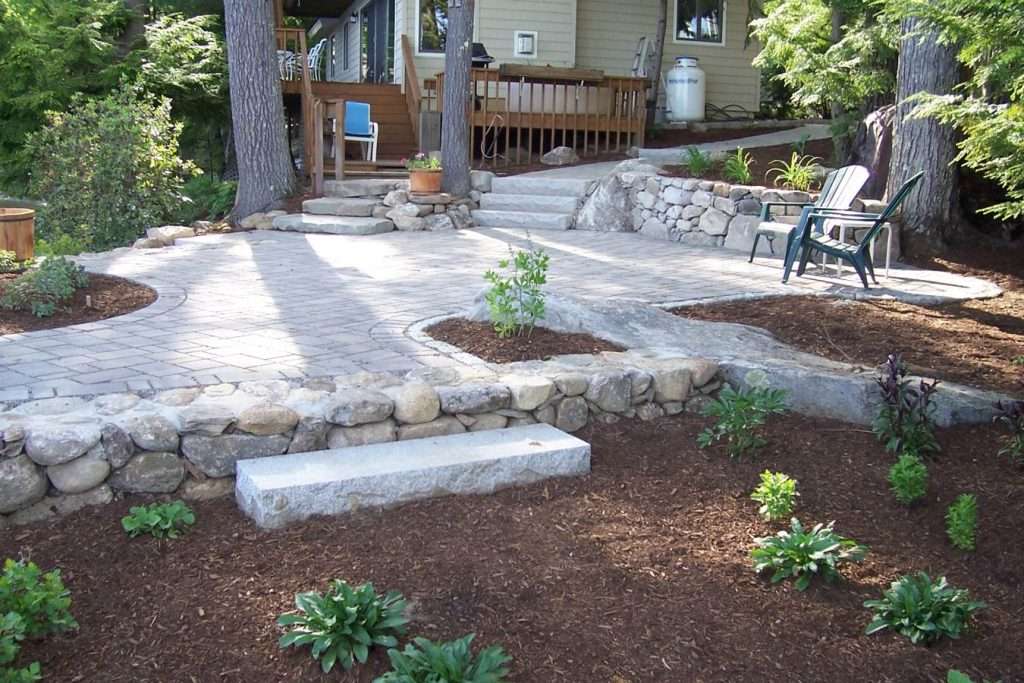 Completed permeable paver patio installation designed for drainage and outdoor living by Landscapes by Tom in New Hampshire