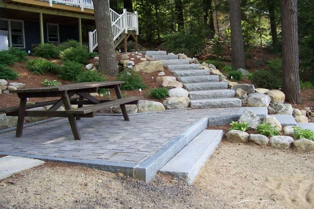 Completed permeable paver patio installation with professional hardscaping and drainage-friendly design by Landscapes by Tom in New Hampshire