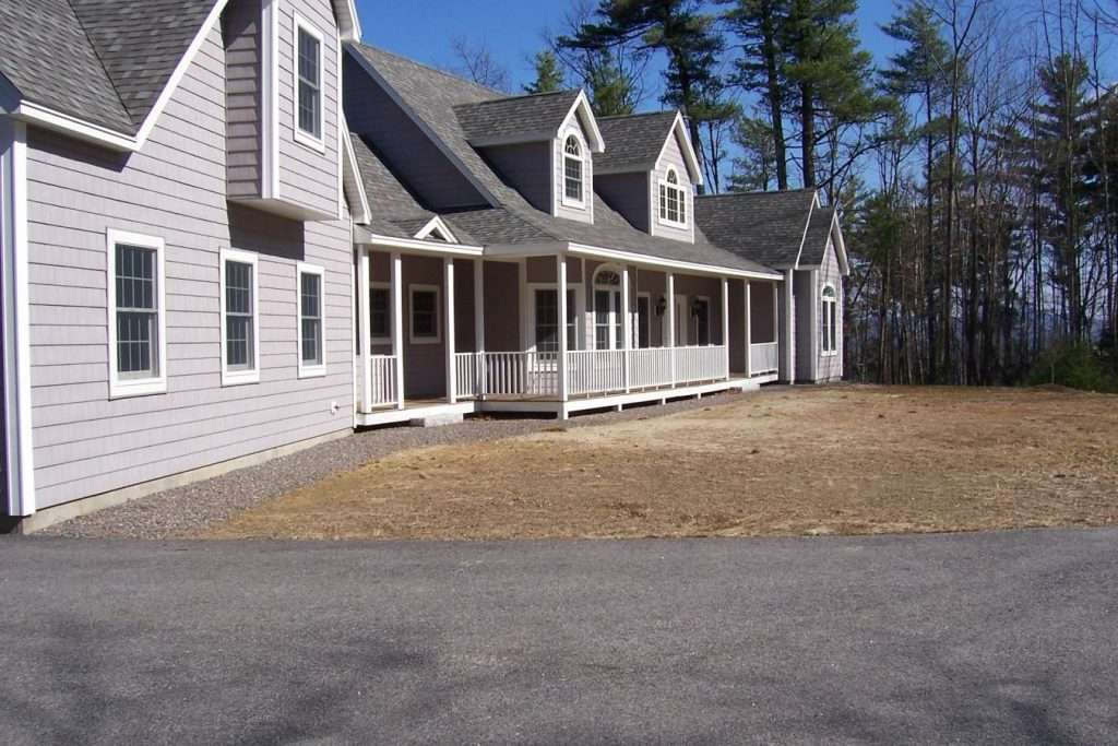 Before photo of a residential entry walkway and planting bed prior to landscape renovation by Landscapes by Tom in New Hampshire