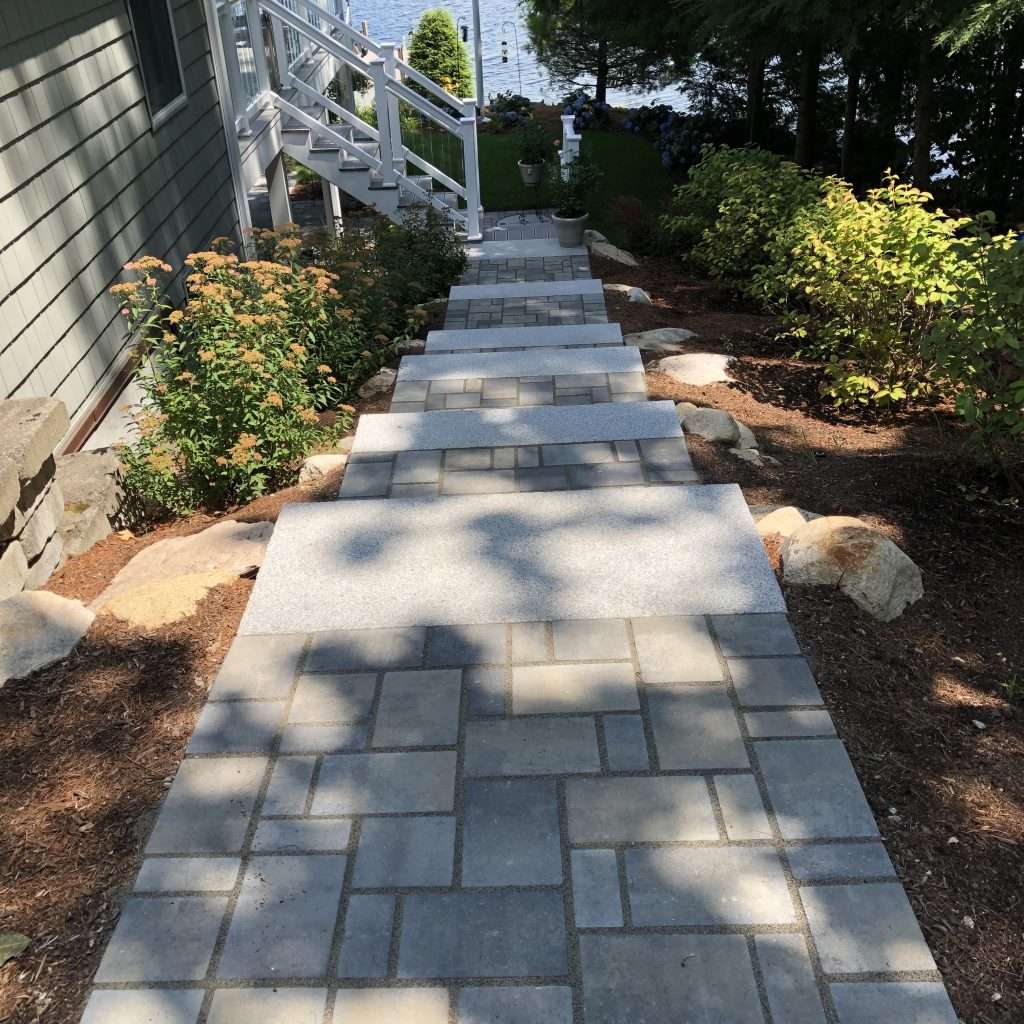 Custom granite step pathway with paver walkway and waterfront landscaping by Landscapes by Tom in New Hampshire