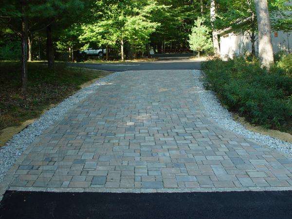 Permeable paver driveway installation designed for improved drainage, stormwater management, and long-lasting curb appeal at a New Hampshire home by Landscapes by Tom