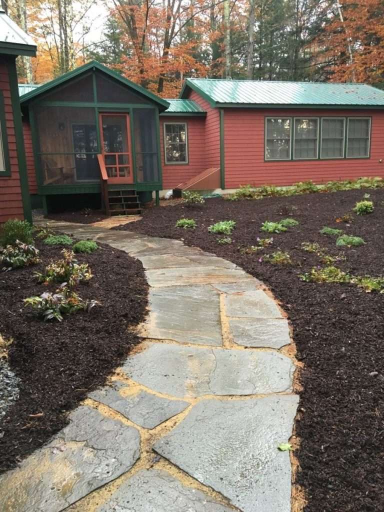 much beds near lake with flagstone path